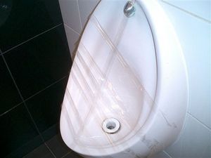 accident waiting to happen - clear tape covers a urinal