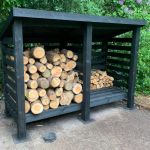 Black log store with two compartments with logs in one and split logs in other