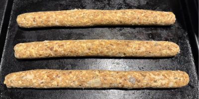 Three veggie sausage roll mixes made in to the sausages and placed on a baking tray ready to go int the fridge