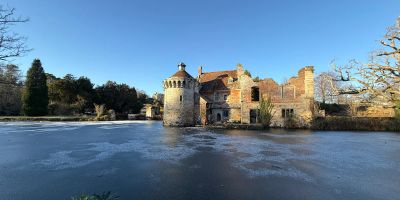Scotney Castle with frozen lake in foreground