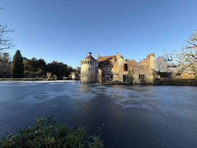 Old Scotney Castle from the south with New Scotney Castle in the background to the left up on the hill behind it.